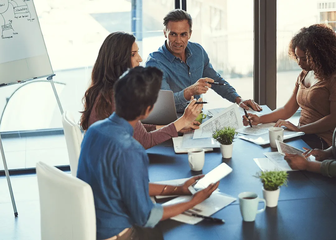 Eine Gruppe von Menschen, die gemeinsam an einem Tisch arbeiten